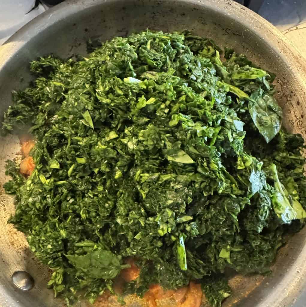 (Image: Fresh spinach piled into the pan)