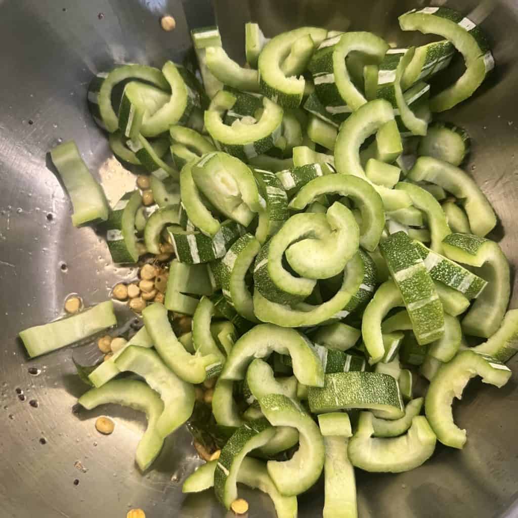 Sliced snake gourd pieces added to tempering with dal.