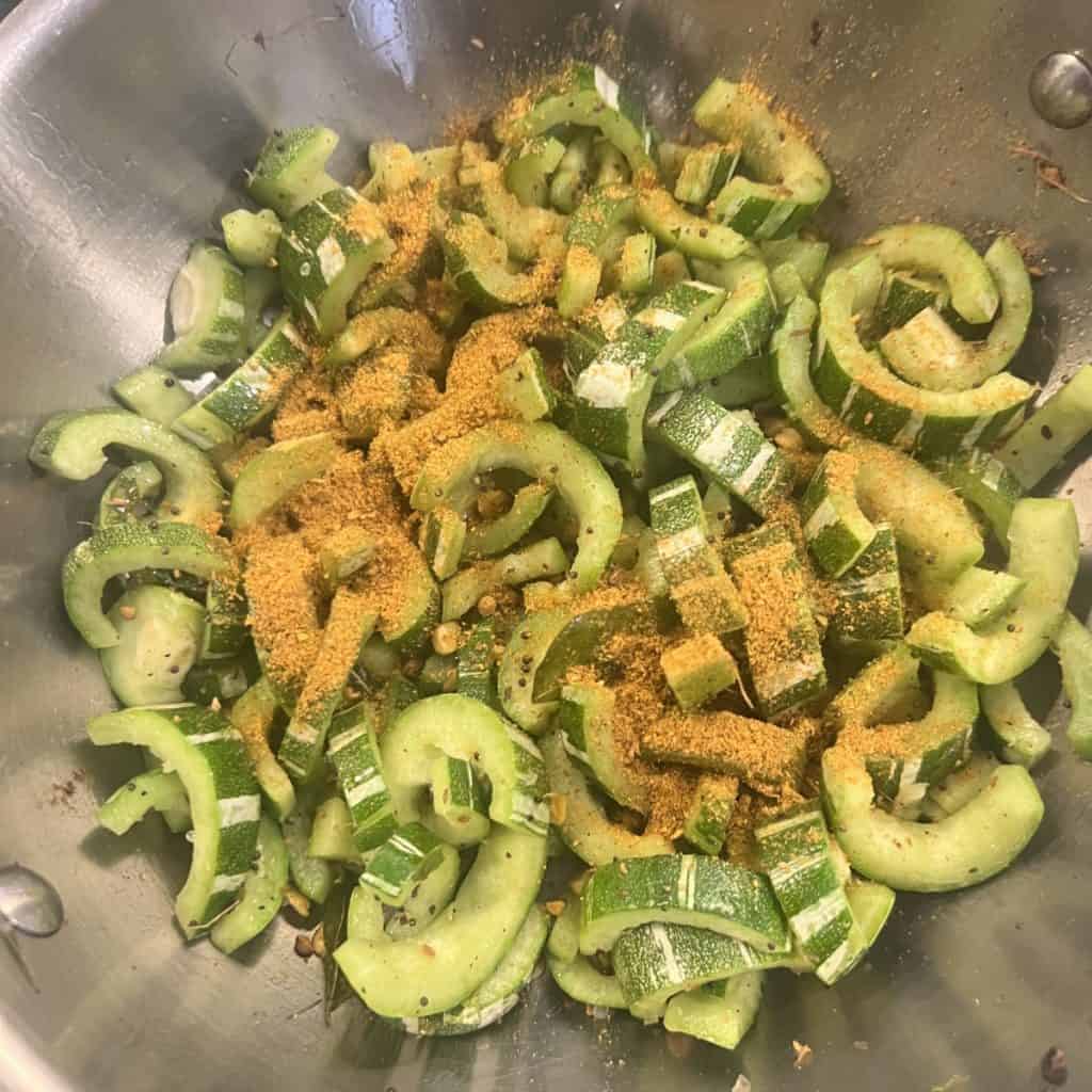Snake gourd slices with sambar powder and turmeric added.